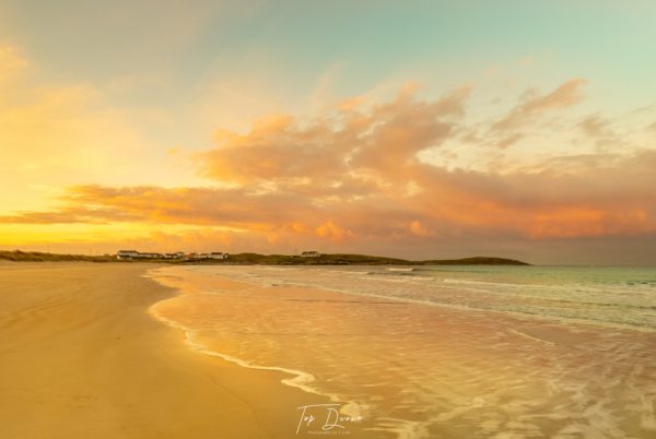 sunsetting on white shore beach