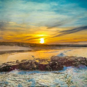 Sunset over arlands beach sea and rocks