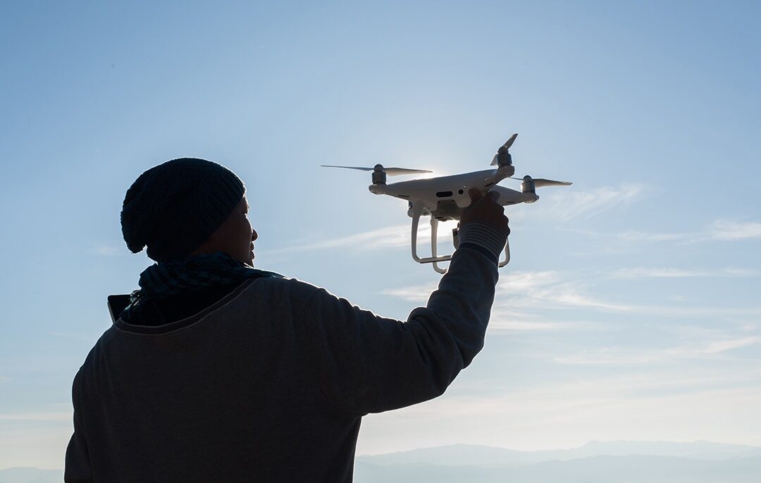 man holding drone up