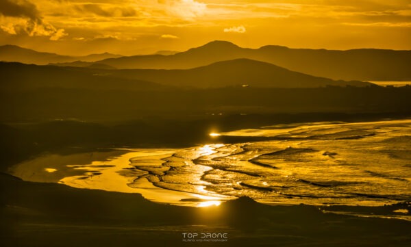 Sunset above the White Shore Beach and Ballyheirnan Bay