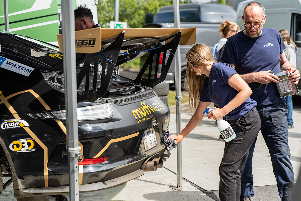 black Porsche rally car muff wash sponsor
